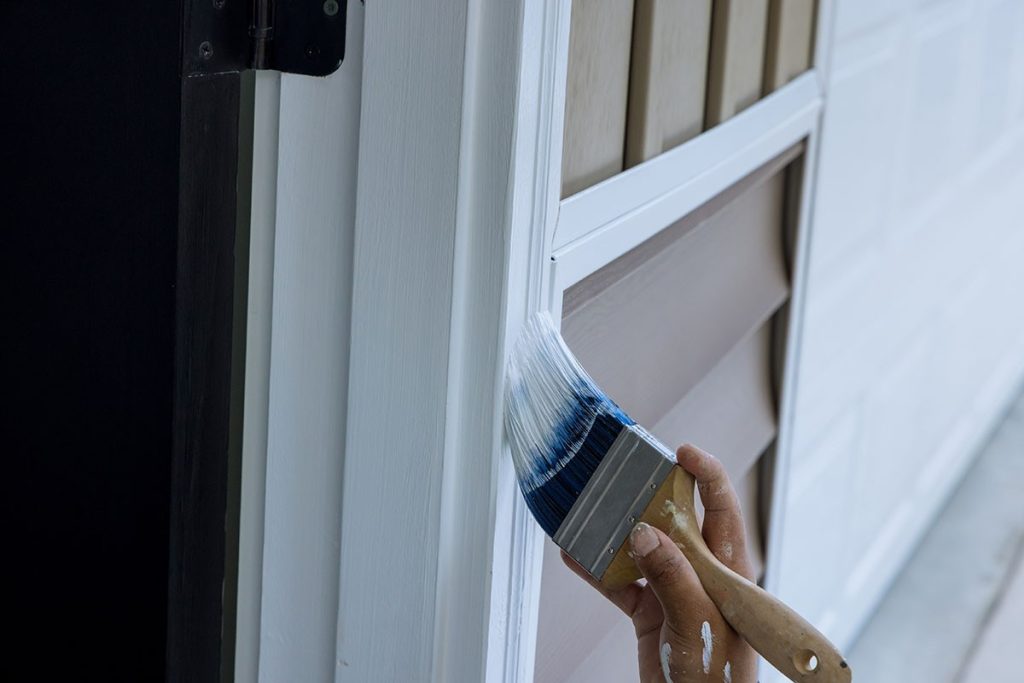 a photo of a paint brush during an exterior painting project